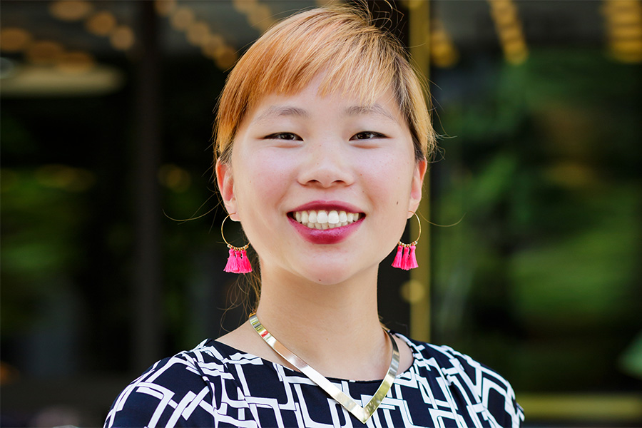 Woman wearing hoop earrings with pink fringe