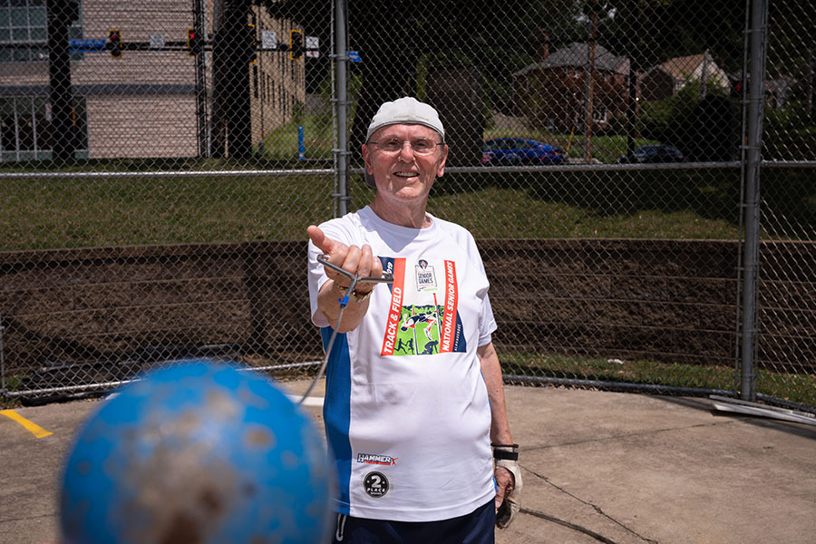 Image of a man swinging a weighted ball on a chain