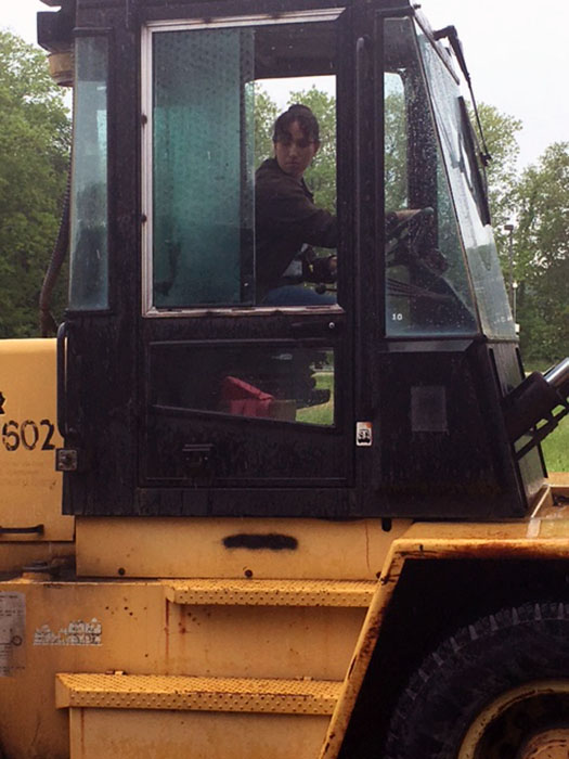 Woman driving front loader