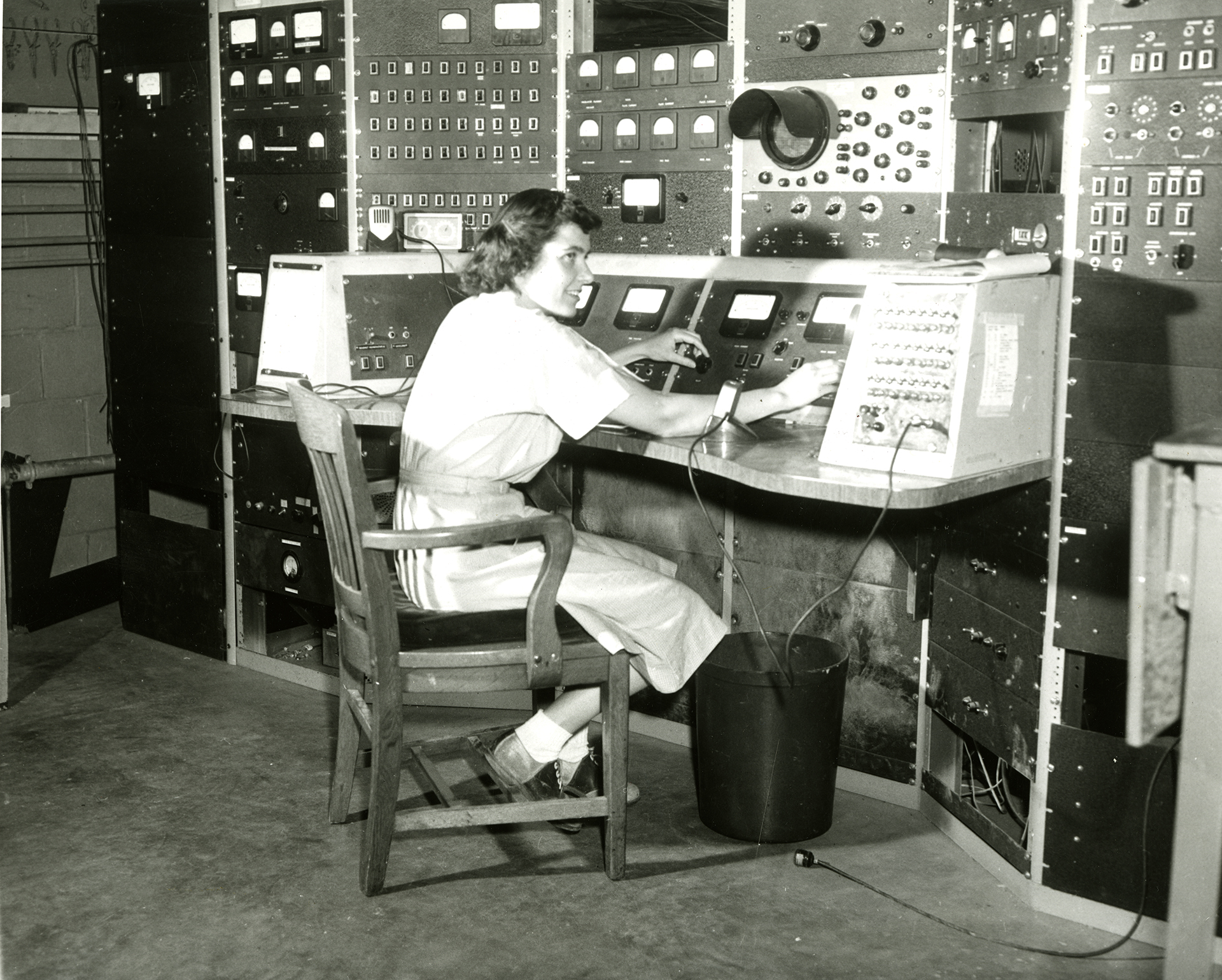 Woman sitting at a control panel