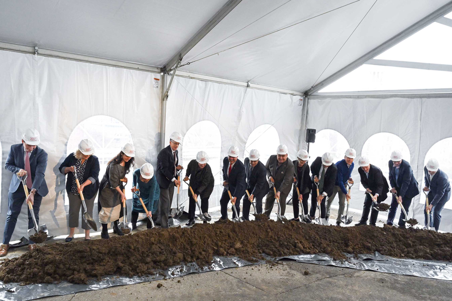 a group of people dig into a pile of dirt