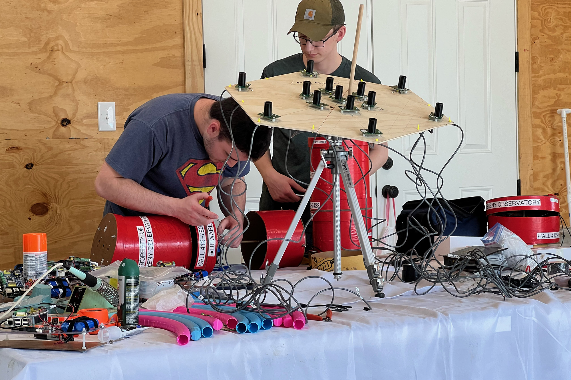 Norris Bach and a member of the Pitt Shadow Bandits work on instrumentation