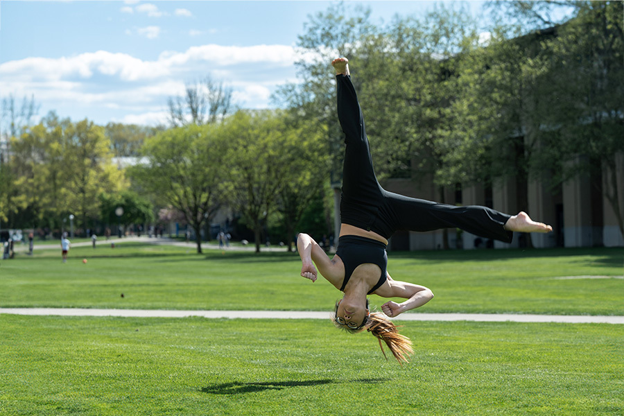 Woman halfway through completing an aerial cartwheel