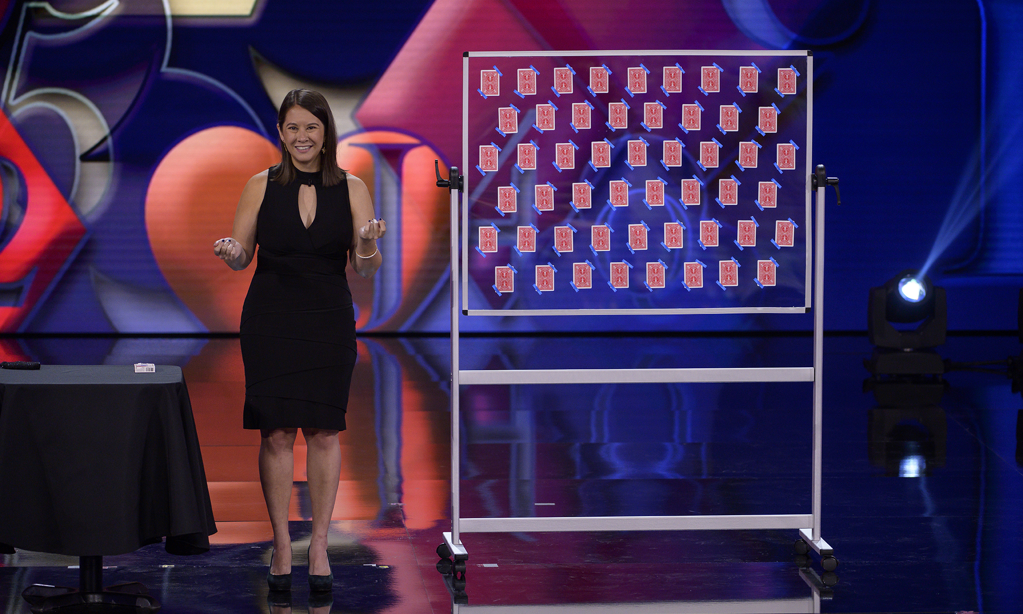 Female on stage at a magic show.