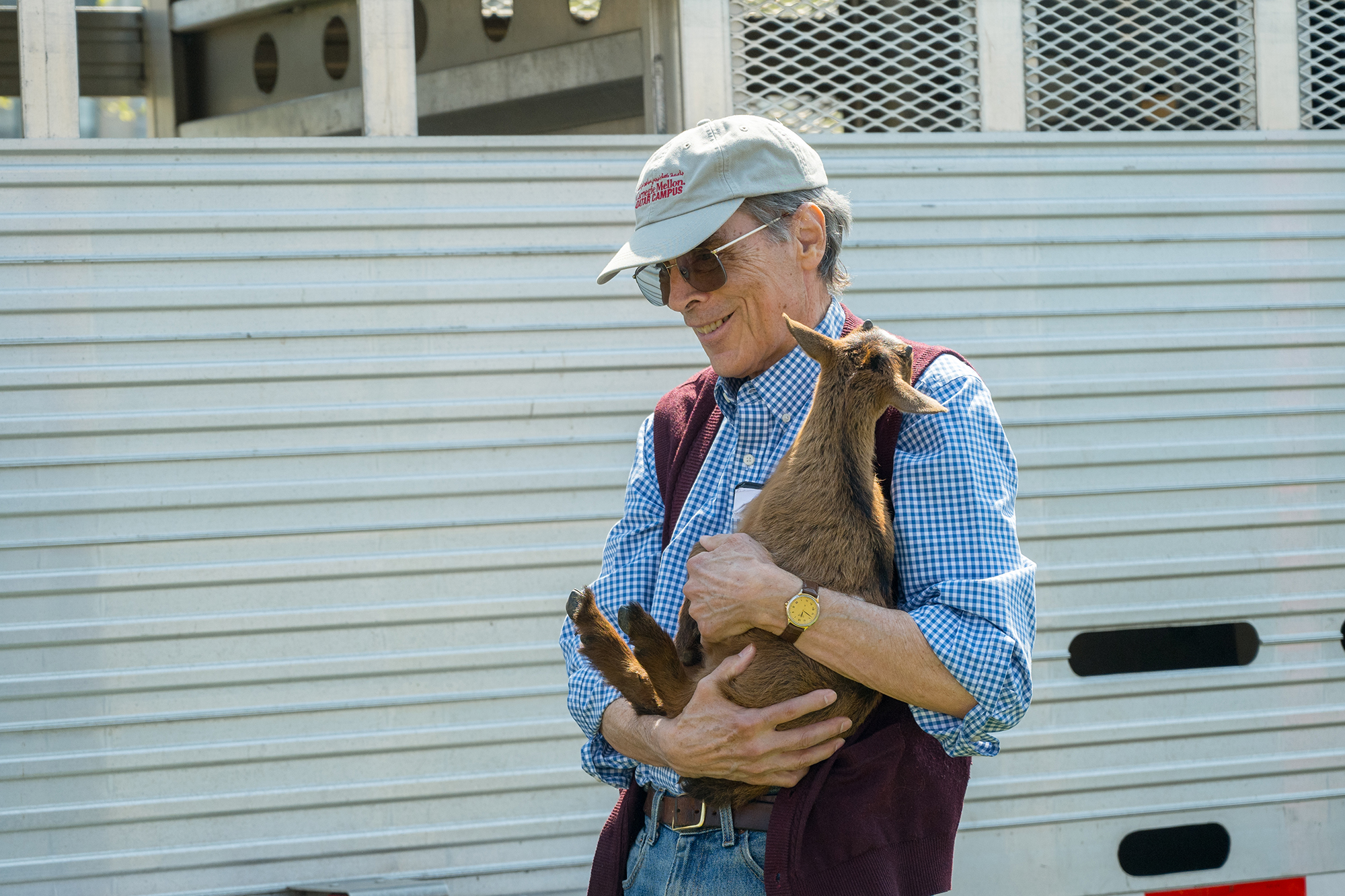 Russell Walker holds a baby goat