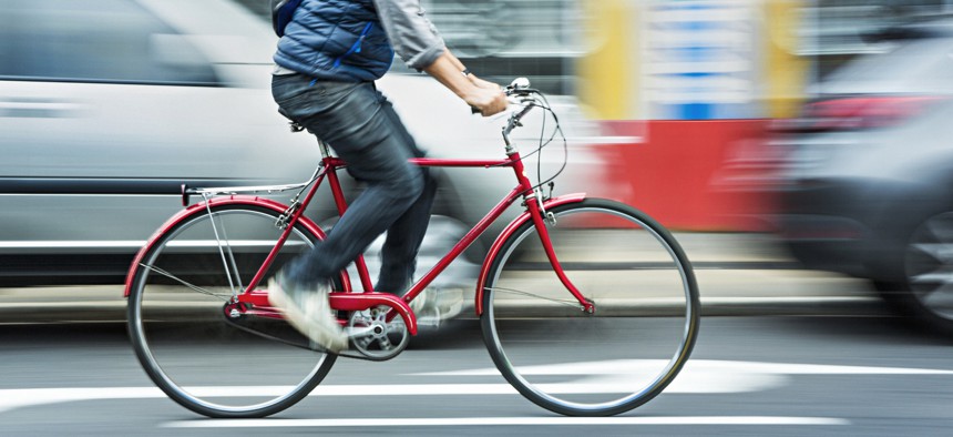 Man riding bicycle in traffic
