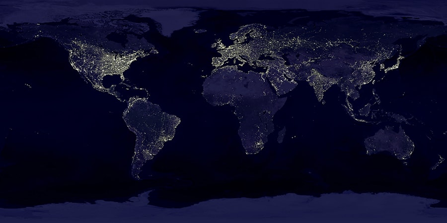 photograph from space of world lit up with city lights