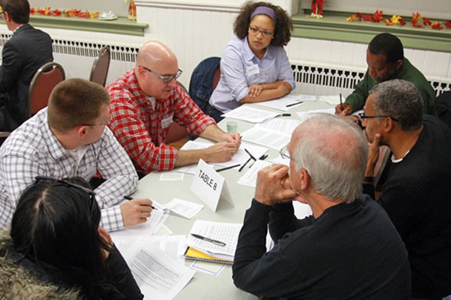 photo of table discussion among a team at a Deliberative Democracy event