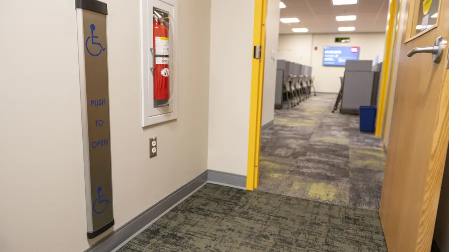 Open doorway into testing center showing automated door opener on left