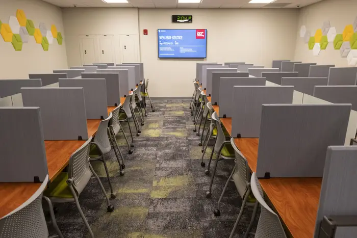 Inside new testing center looking down wide aisle between carrels