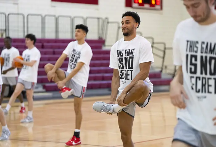 Josiah Smith stretches with the team before the game. 