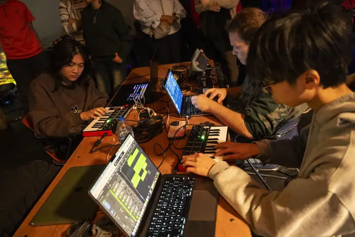 students working on laptops at table