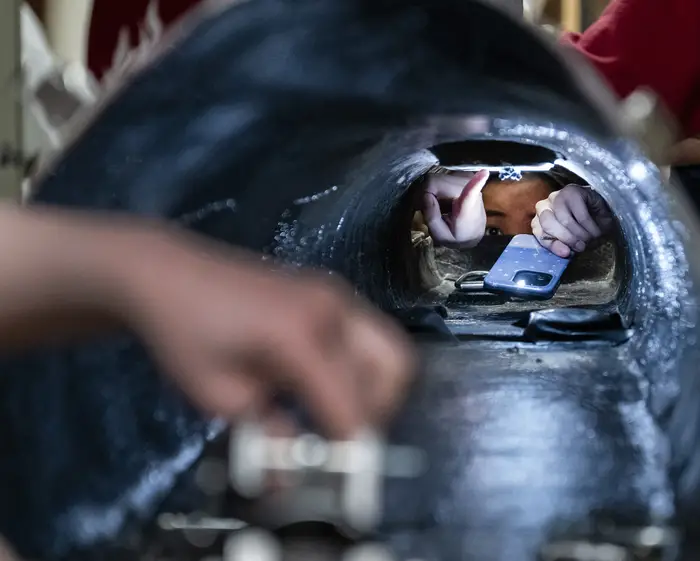 Apex members inspect the inside of a buggy. 