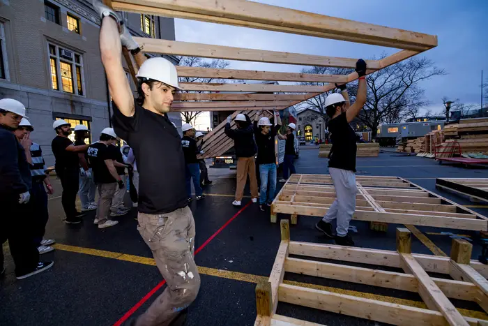 CMU students carry the materials to build booths.