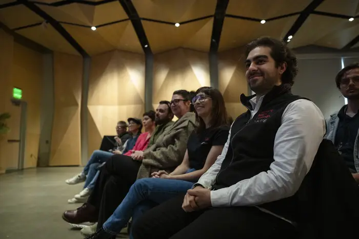 Students listen to John Wells' talk.