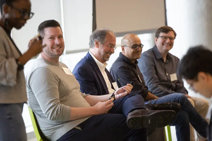 Six people were committed to a lively discussion at a conference