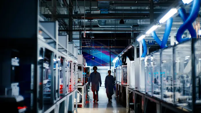 Two people walk through the Bakery Square lab.