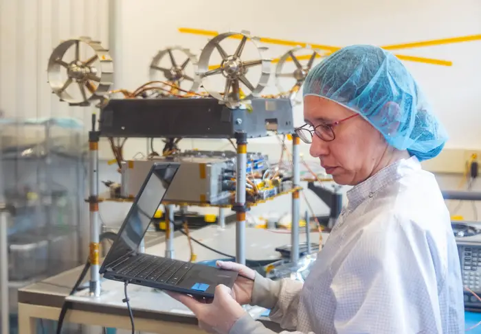 Heather Jones tests MoonRanger in a clean lab. 