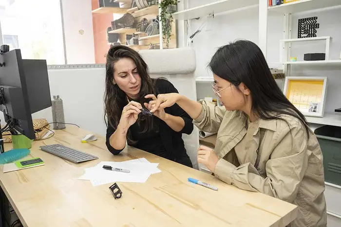HCII faculty member Alexandra Ion and grad student Yuyu Lin assess the brace prototype they customized and 3D printed.