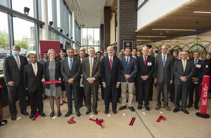 A group photo at the ribbon cutting for TCS Hall