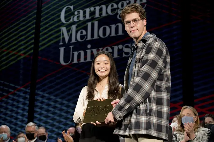 Eugene Young and Emma Kim hold the 2026 class tile
