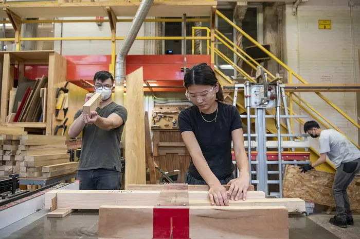 Students make seating for the project in a shop.