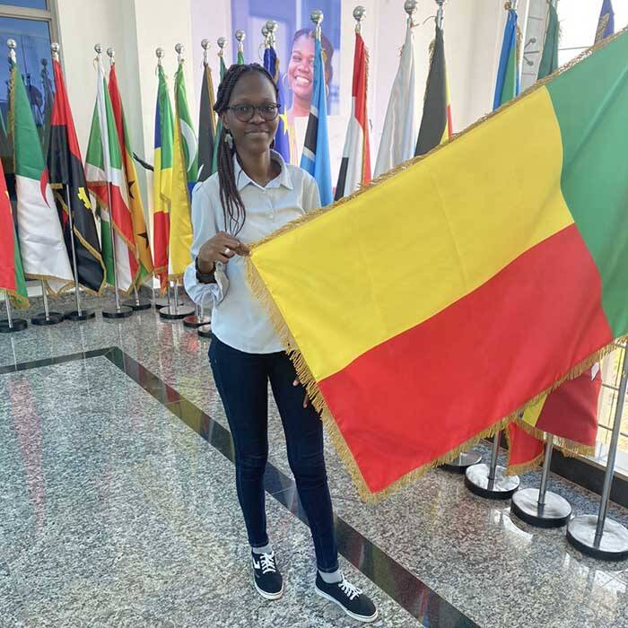Choukouriyah Arinloye with the flag of Benin, her home country.
