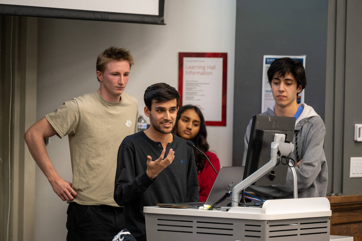 four students presenting to class