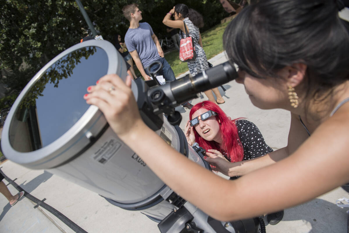 Students look through a telescope