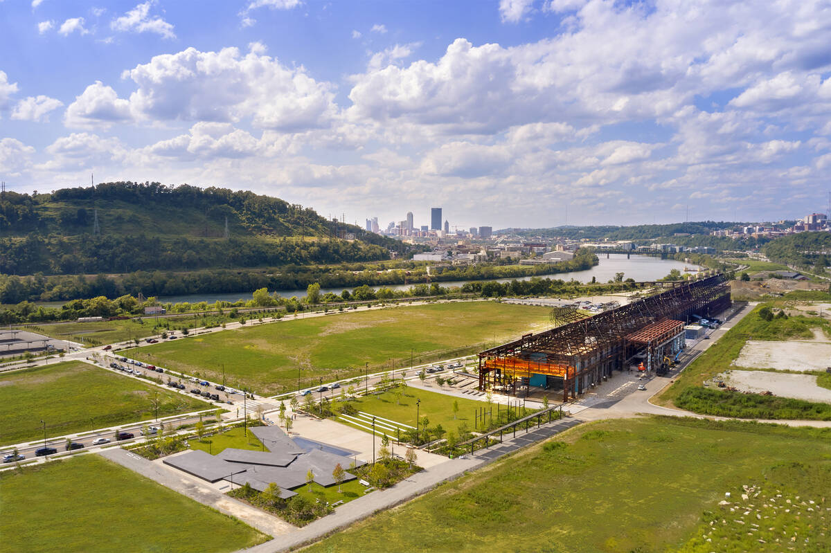 aerial view of Mill 19 in foreground with Pittsburgh, hills and sky in background