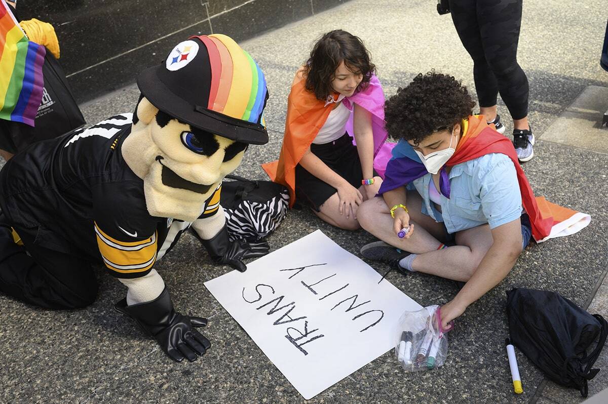 Pride marchers make signs