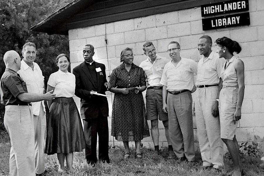 black and white image of Highlander participants and workshop leaders standing outside Highlander Library on the school's 25th anniversary in 1957