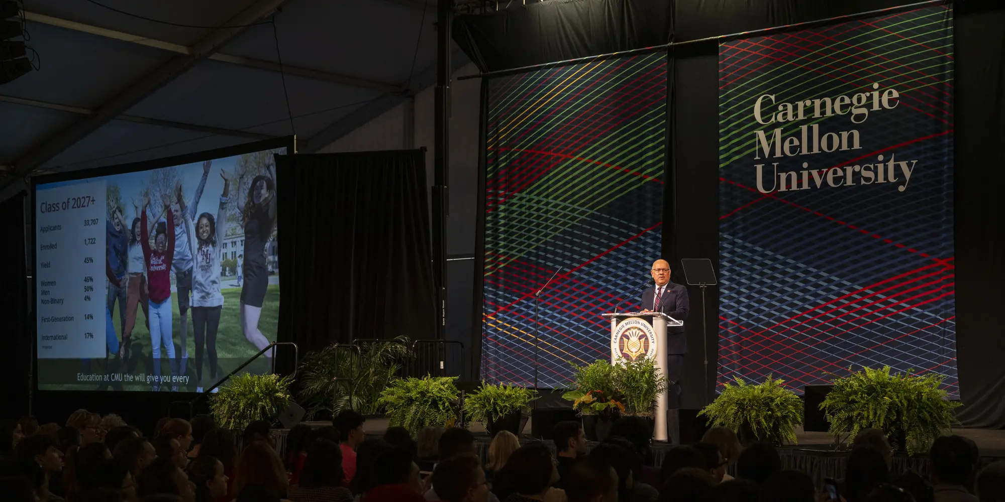 View of stage and large screen while President Jahanian is at podium