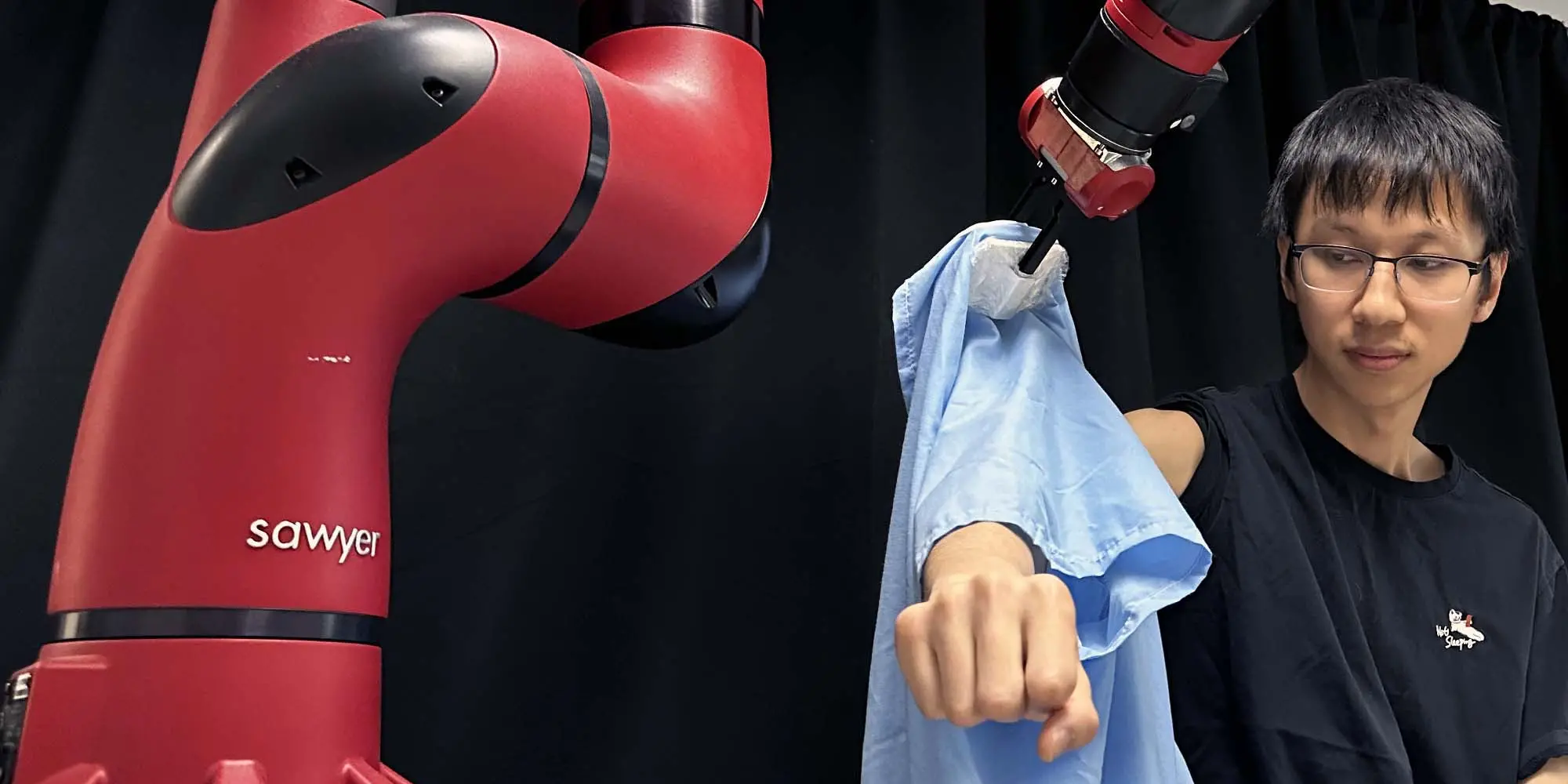 A robot helping a student get dressed.