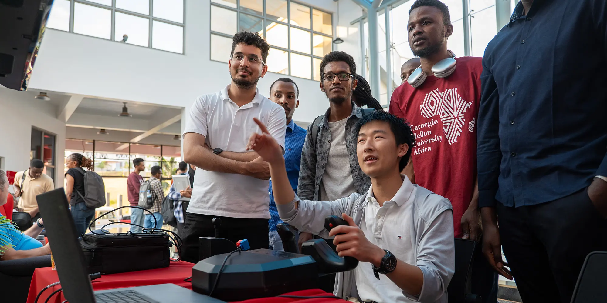 students standing around simulator demo