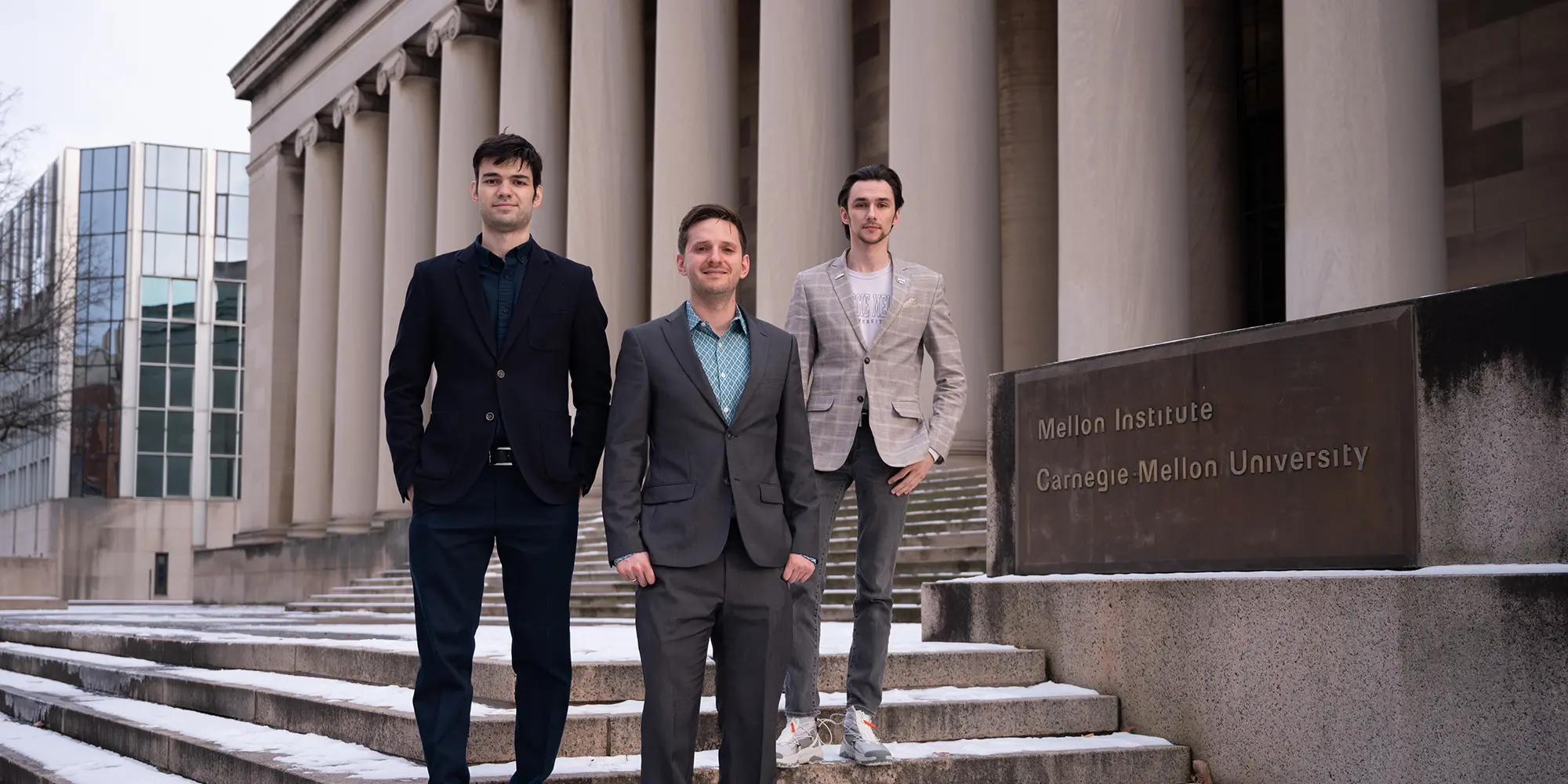 three men standing on steps of Mellon Institute