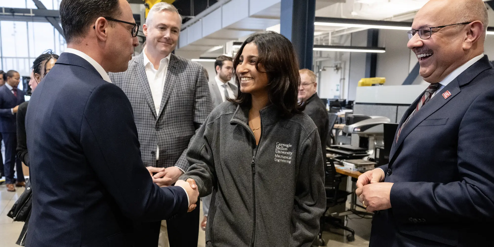 Gov. Shapiro greets Aparna Nair, a recent CMU graduate who works at the ARM Institute.