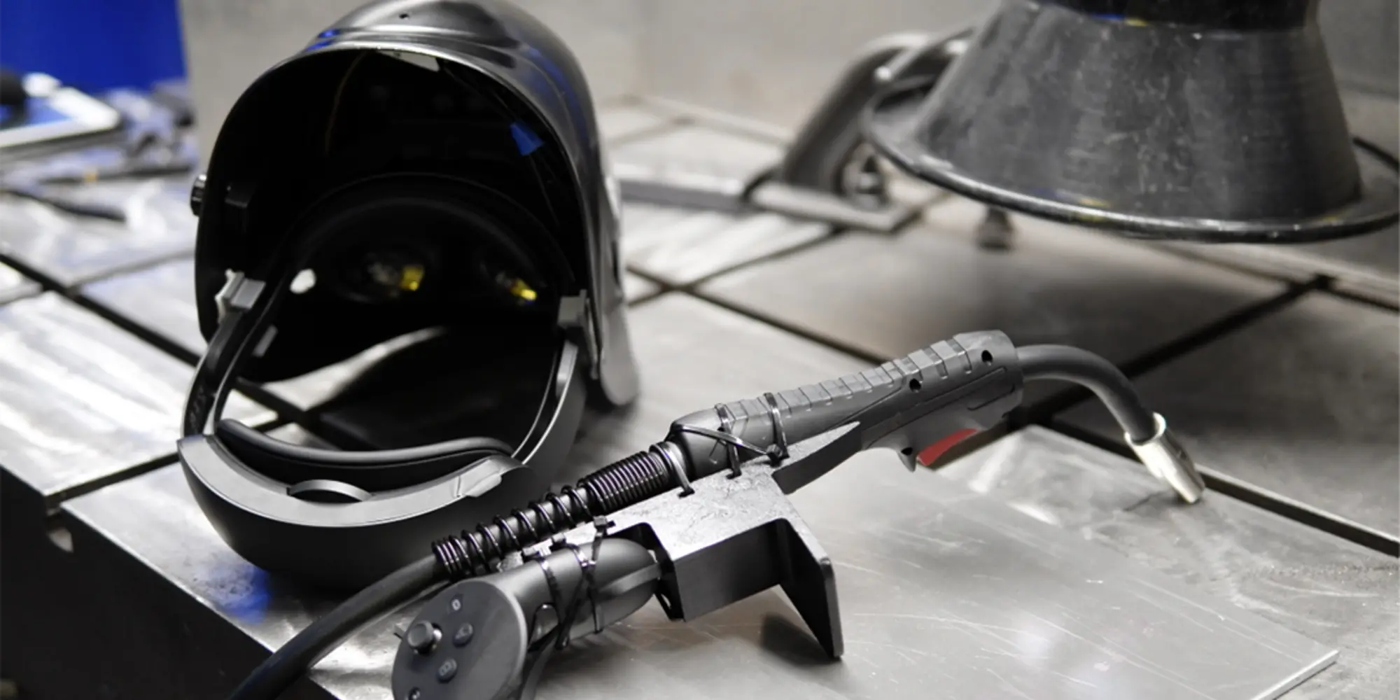 Photo of a welding helmet and torch