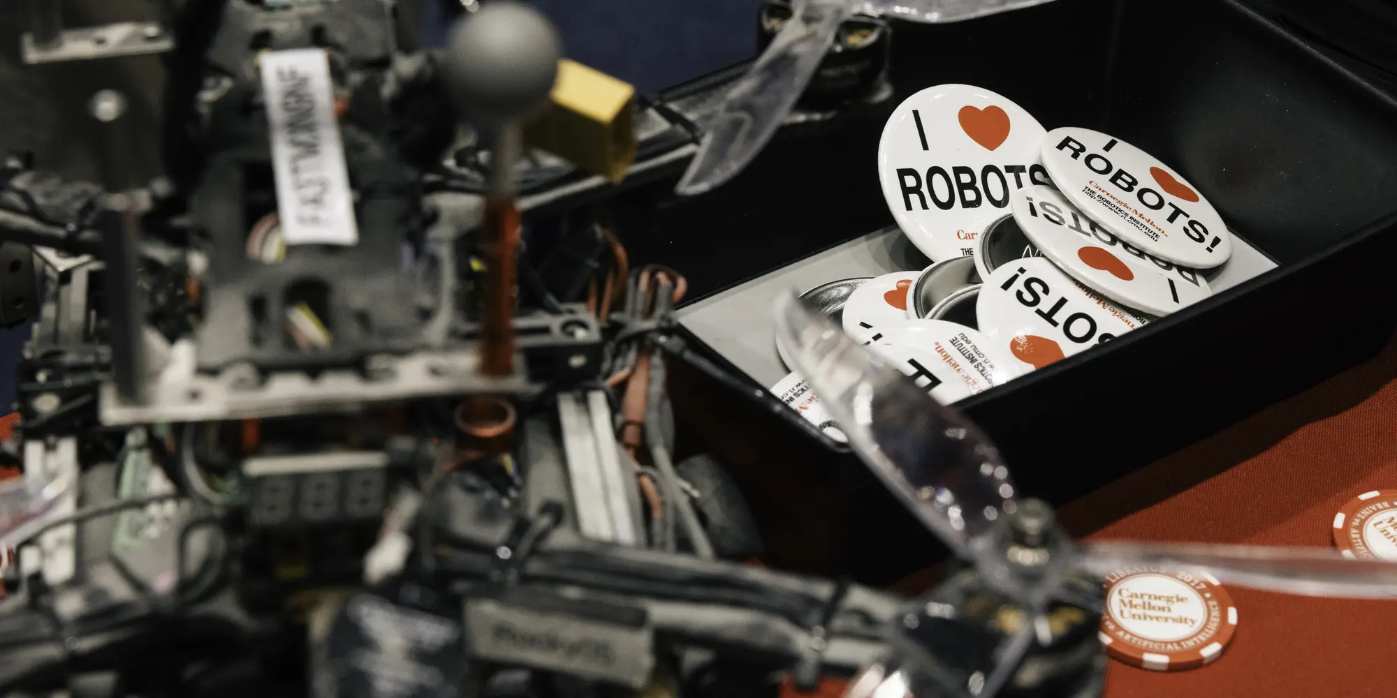 Cave exploring robot on a table next to "I Love Robots" buttons