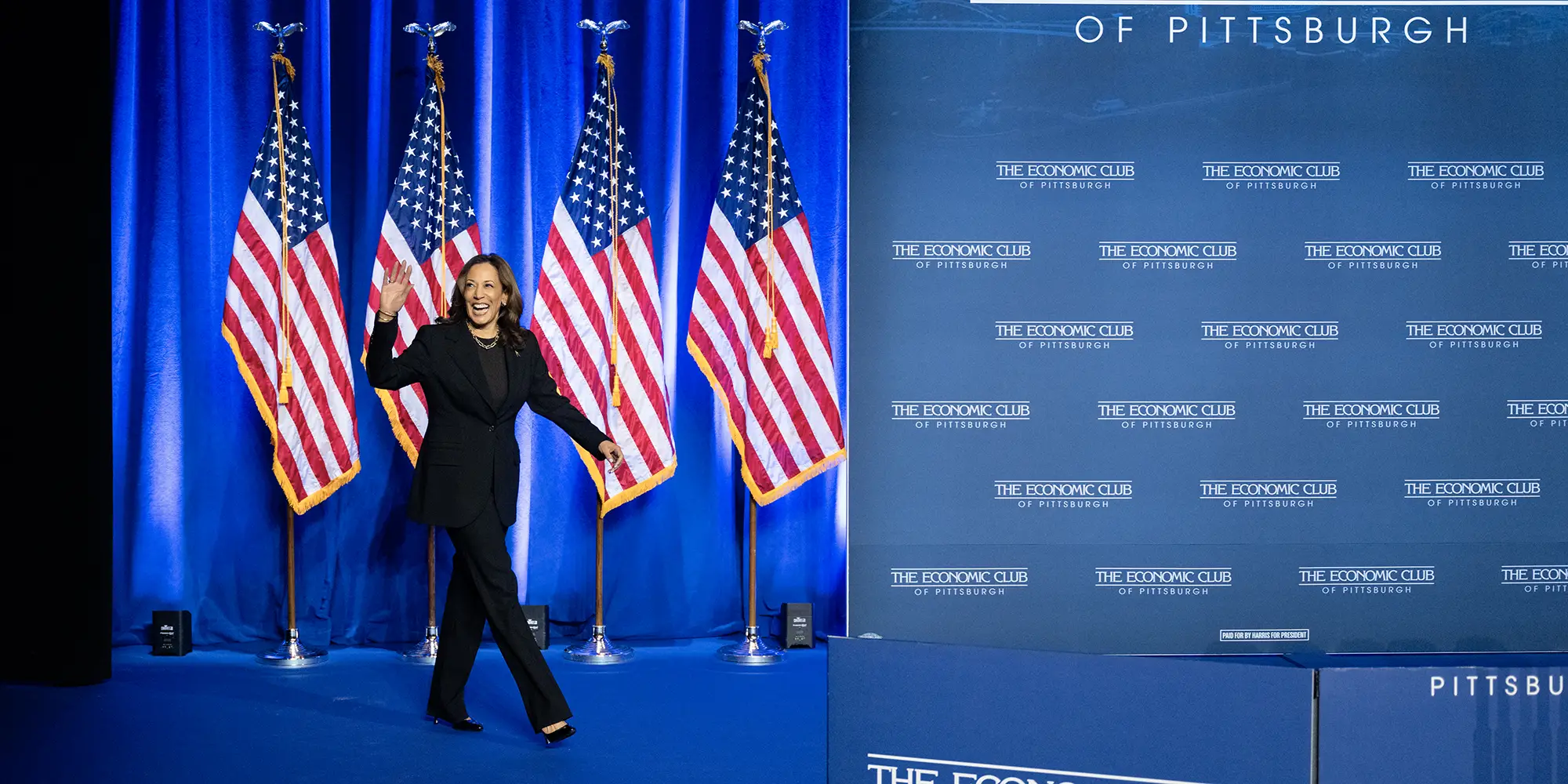 Kamala Harris in front of American flags at Carnegie Mellon.