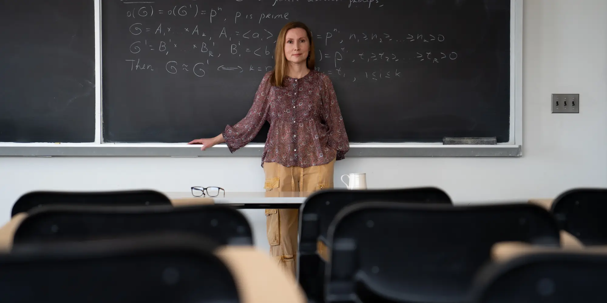 Irina Gheorghiciuc, associate teaching professor in the Department of Mathematical Sciences, stands in front of a chalkboard.