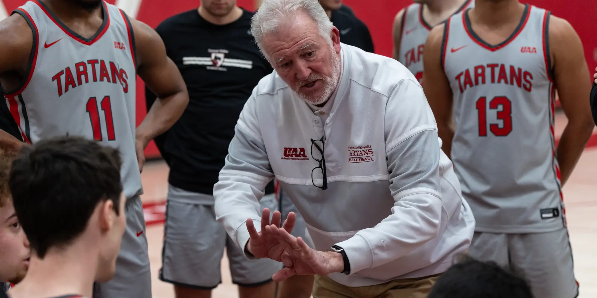 Tony Wingen, head Men’s basketball coach, talks to his team during a timeout.