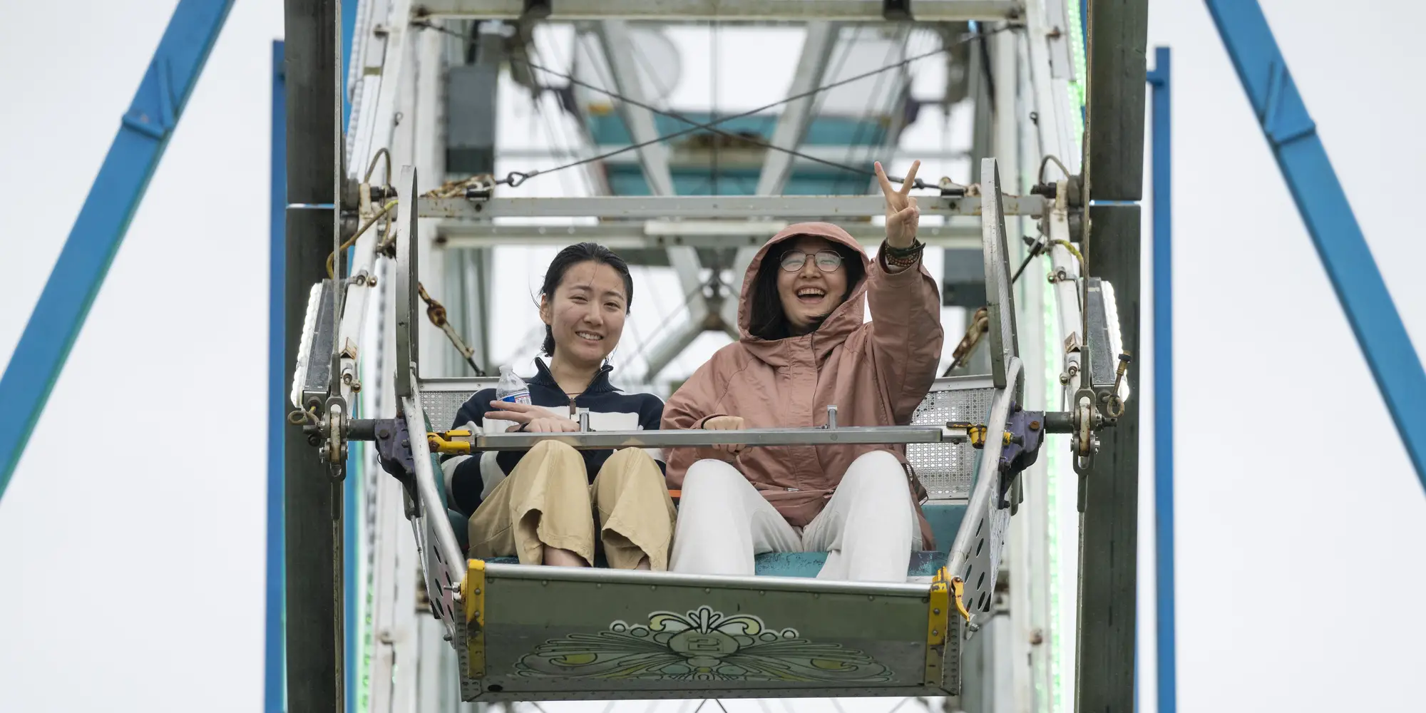 Carnival-goers ride the Ferris wheel. 