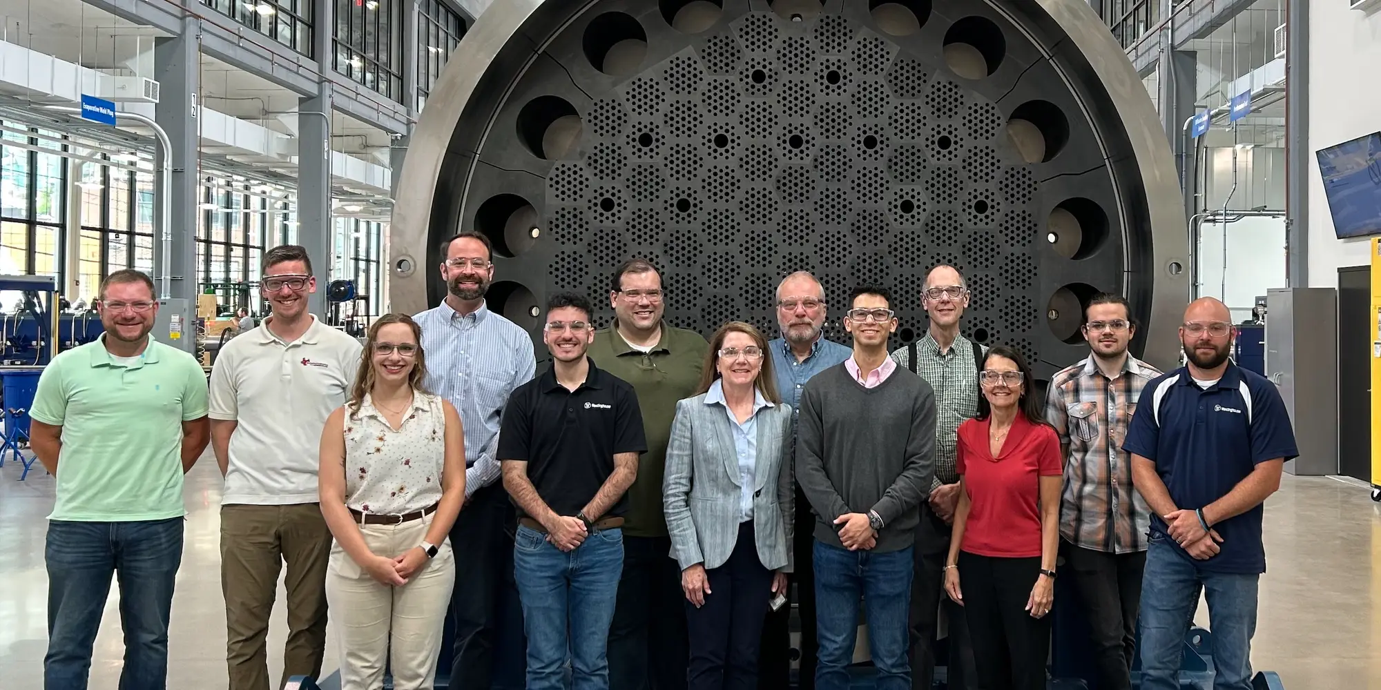 people standing in front of microreactor