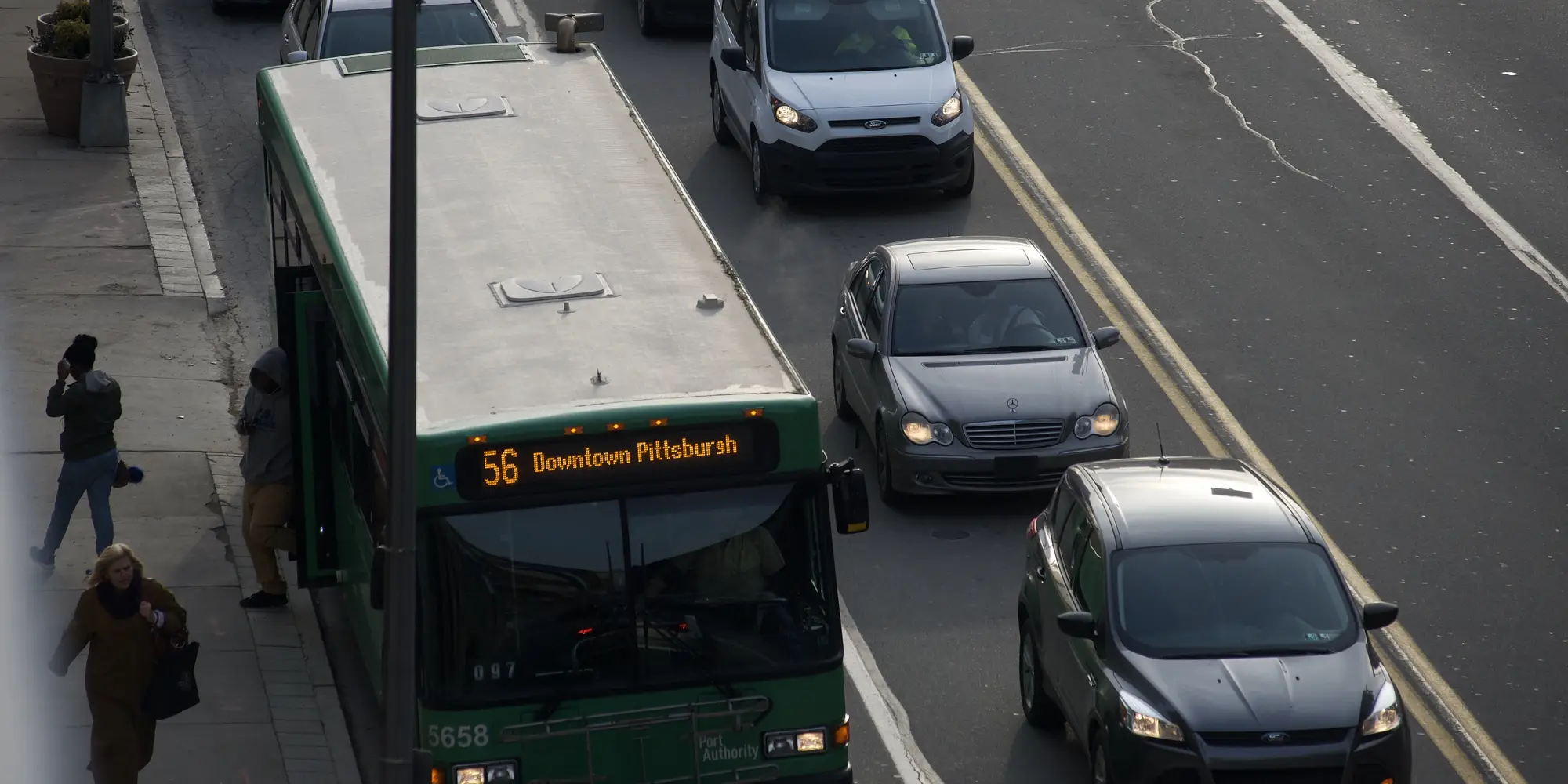 Cars and a bus are shown in heavy traffic