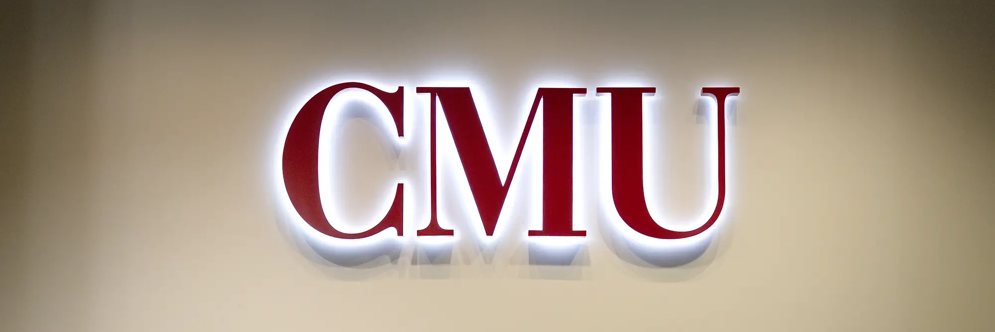 Red CMU letters with light protruding from behind.