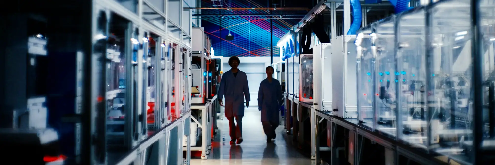 Two people walk through the Bakery Square lab.