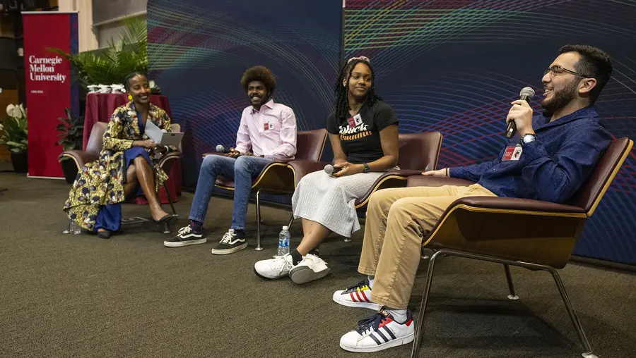 panel discussion showing four people sitting on a stage