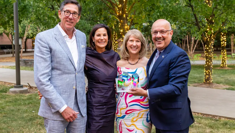 Farnam Jahanian standing with three people outdoors