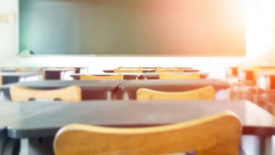 view of front of classroom from behind desks and chairs